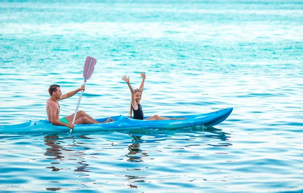 Sporty attractive family kayaking on sea together — Stock Photo, Image