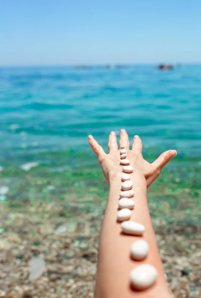 Handful of sea stones on the beach. Conceptual design — Stock Photo, Image