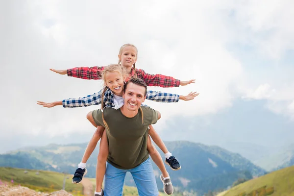 Beautiful kids and happy man in mountains in the background of fog — Stock Photo, Image