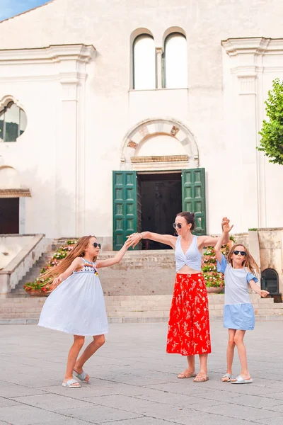 Adorable little girls and young mother have fun in italian old village — Stock Photo, Image