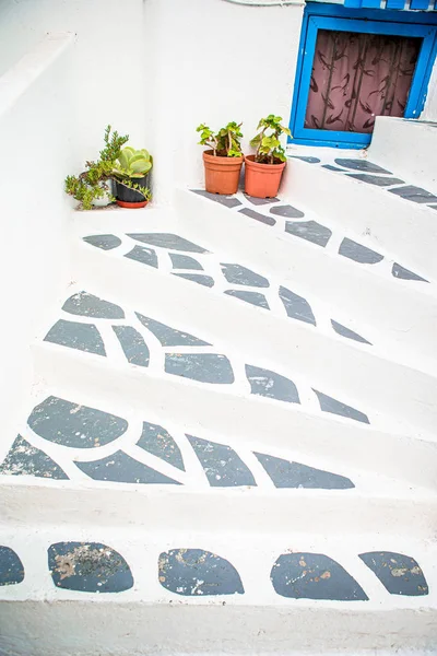 Traditional greek colorful flowerpots with flowers on steps on streets of old village in Greece — Stock Photo, Image