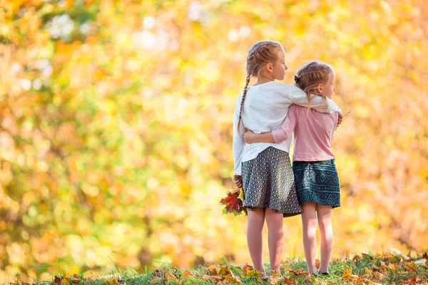 Little adorable girls outdoors at warm sunny autumn day — Stock Photo, Image