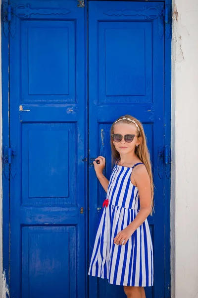 Adorable little girl at old street of typical greek traditional village — Stock Photo, Image