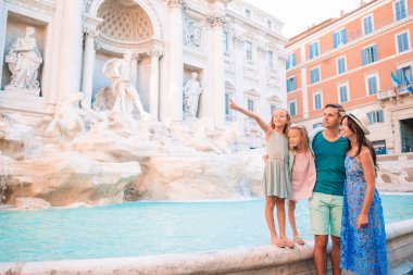 Şehir haritasıyla Fontana di Trevi yakınlarında mutlu bir aile.