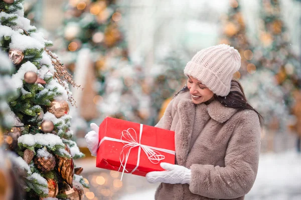 Happy girl near fir-tree branch in snow for New year. — Stock fotografie