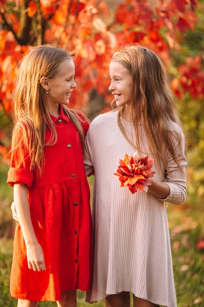 Little adorable girls outdoors at warm sunny autumn day — Stock Photo, Image