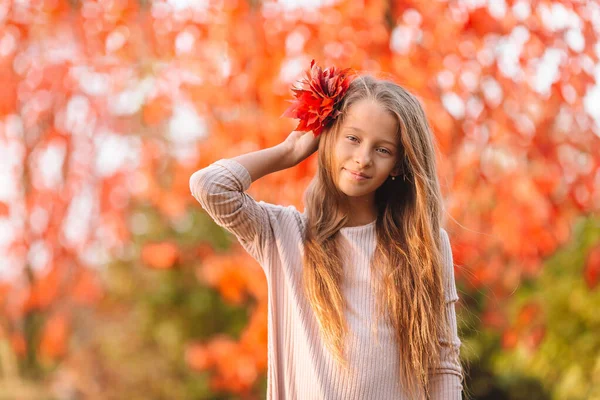 Portrait of adorable little girl with yellow leaves bouquet in fall — Stock Photo, Image