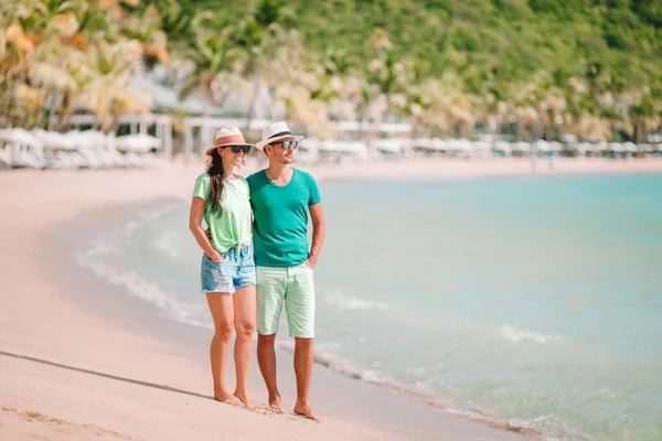 Jong koppel lopen op tropisch strand met wit zand en turquoise oceaanwater op Antigua eiland in Caribisch gebied — Stockfoto