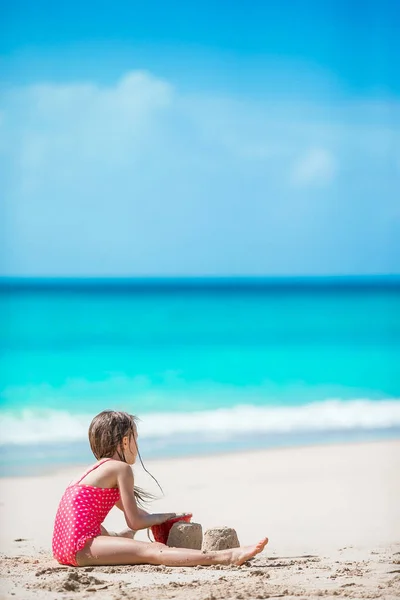 Adorable little girl in swimsuit at tropical beach — Stock Photo, Image