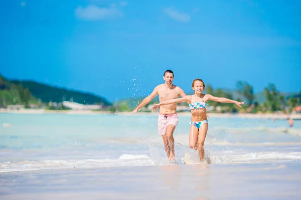 Vader en kinderen genieten van strandvakantie — Stockfoto