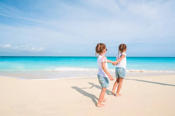 Adorable little girls have a lot of fun on the beach. — Stock Photo, Image