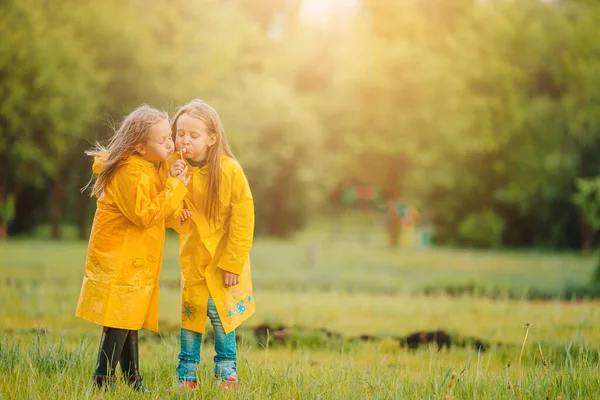 Adorable little girls under the rain on warm spring day — Stock Photo, Image