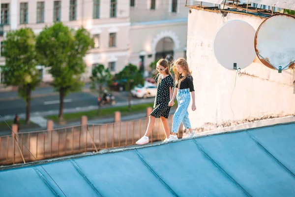 Roztomilé dívkyna střeše těší s výhledem na krásný západ slunce v Sankt Petersburg v Rusku — Stock fotografie