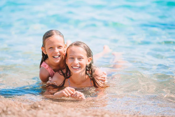 Adorable little girls having fun on the beach — Stock Photo, Image