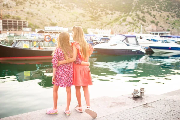 Adorable little girls in port at summer — Stock Photo, Image