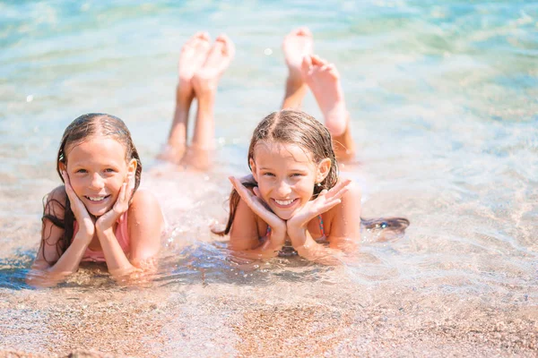 Adorable little girls having fun on the beach — Stock Photo, Image