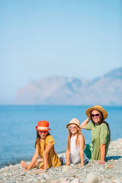 Söta små flickor och ung mor på tropisk vit strand — Stockfoto