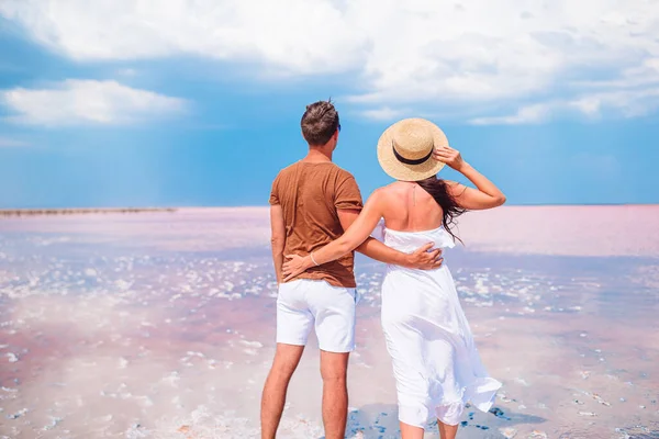 Young couple on white beach during summer vacation.