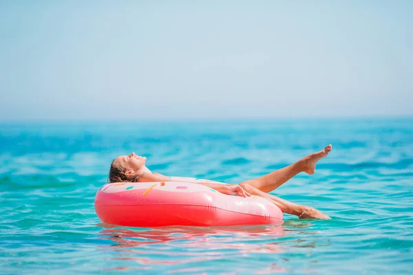 Schattig meisje op opblaasbare lucht matras in de zee — Stockfoto