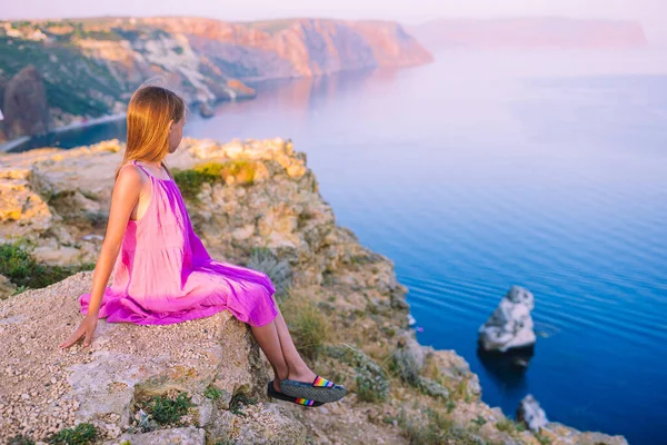 Little girl on top of a mountain enjoying valley view before sunset — Stock Photo, Image