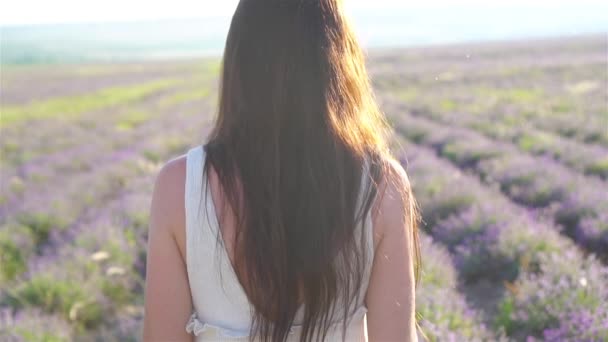 Žena v levandulové květy pole při západu slunce v bílých šatech a klobouku — Stock video