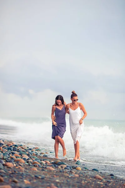 Young women in white on the beach — Stock Photo, Image