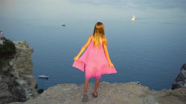 Little girl on top of a mountain enjoying valley view before sunset — Stock Video