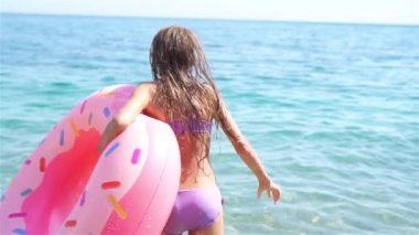 Yaz tatili boyunca sahilde sevimli, aktif küçük bir kız.