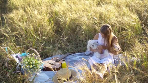 Mooi klein meisje in tarweveld met rijpe tarwe in handen — Stockvideo