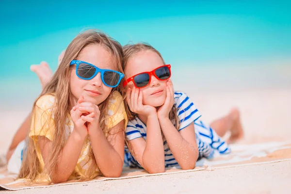Két boldog kislány jól szórakozik a trópusi parton, együtt játszanak. — Stock Fotó