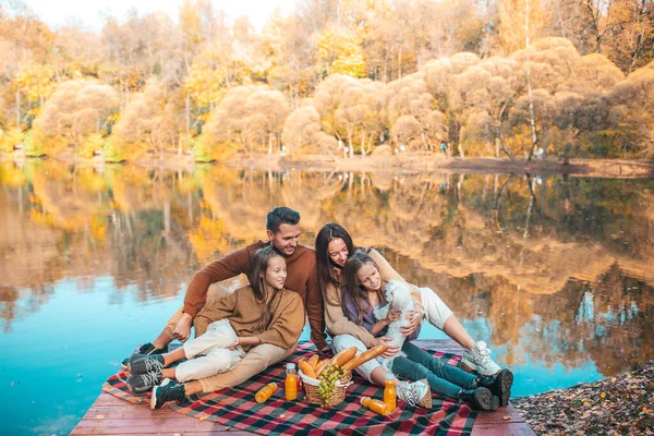 Glückliche Familie bei einem Picknick im Park im Herbst — Stockfoto