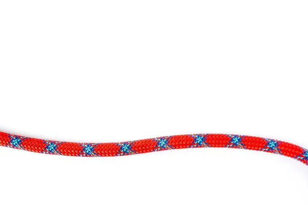 9.8 mm climbing rope strand, isolated on white background. String of mountaineering coil rope with red and blue abstract "X" pattern on it, and space for text. — Stock Photo, Image