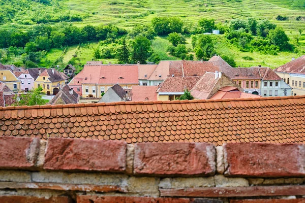 Layers of traditional house roofs in Biertan, Transylvania, Romania. Scenic view from the upper walls of the Fortified Church in Biertan.