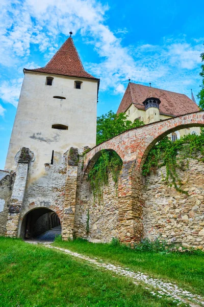 Defense tower and exterior walls of Biertan fortified church, in Transylvania, Romania. Tourism concept for scenic locations and perfect, blue sky weather.