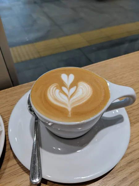 coffee milk with a heart shape with a spoon with motion blur