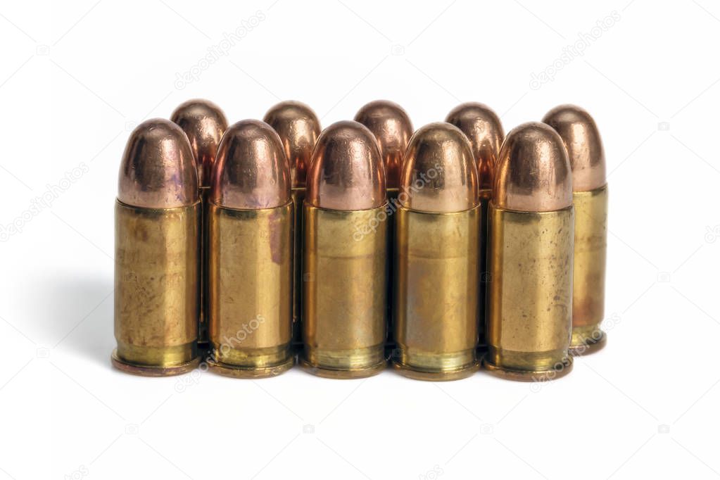 Ten pistol bullets in line isolated on white background.