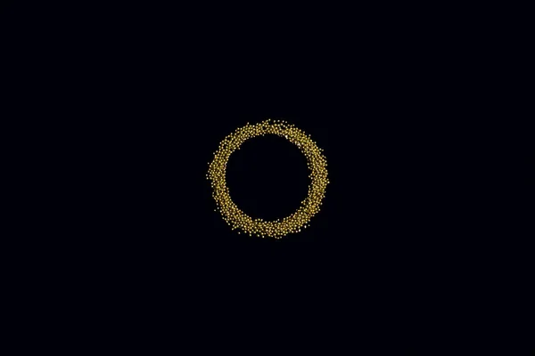 ring from edible gold sprinkles on a black background