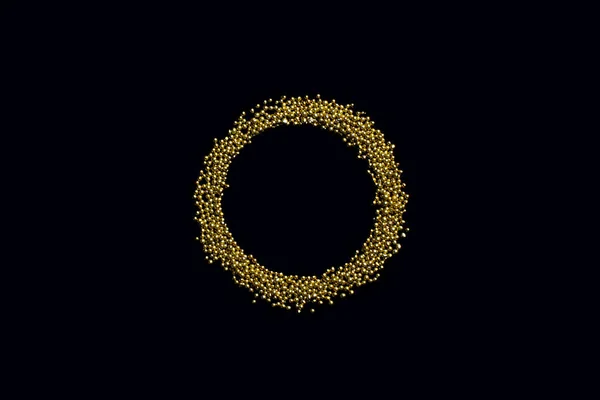 ring from edible gold sprinkles on a black background