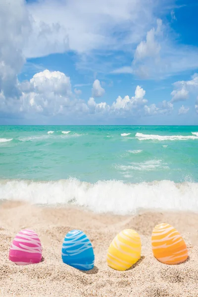 Happy easter lettering background with eggs on the sandy beach — Stock Photo, Image