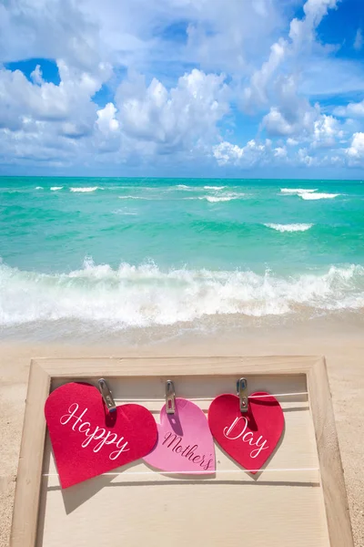 Happy Mothers day beach background with hearts — Stock Photo, Image