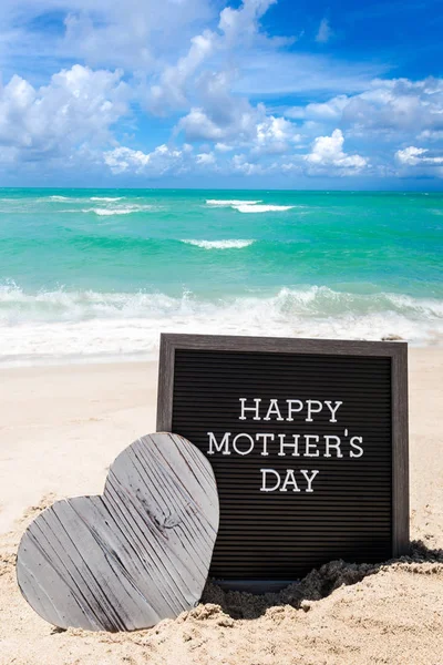 Щасливий день матері пляжний фон з чорною дошкою і серцем — стокове фото