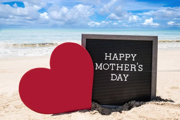 Happy Mothers day beach background with black board and heart