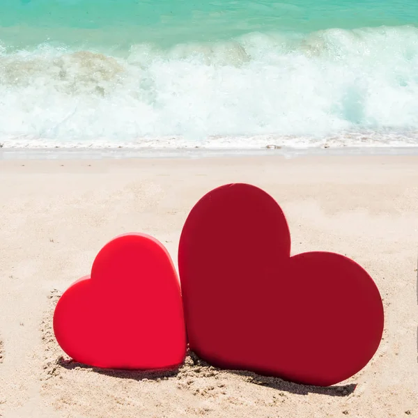 Two hearts on the sandy beach background — Stock Photo, Image