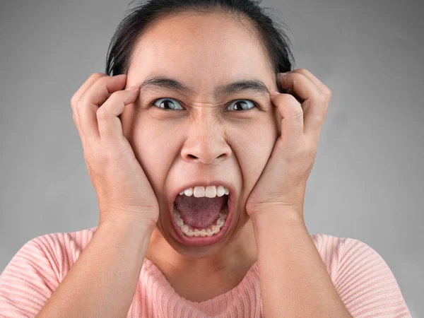 Furious and frustrated woman yelling with hand on face, Isolated