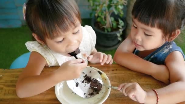 Close Portrait Two Pretty Little Girls Enjoy Eating Chocolate Cake — Stock Video