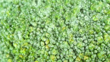 Tahta doğrama tahtasının üzerine su damlatılan taze yeşil brokoliyi kapat..