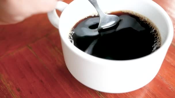 Close Person Hand Stirring Black Coffee Spoon White Cup Wooden — Stock Video