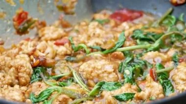 Kızarmış kıymalı domuz kızartması, biberli kızartma tavası, istiridye sosu, mutfaktaki gazdan çıkan sıcak şeker ve kırmızı biberli patates kızartması yapan kadınların yakın çekimi. Lezzetli Tayland yemekleri..