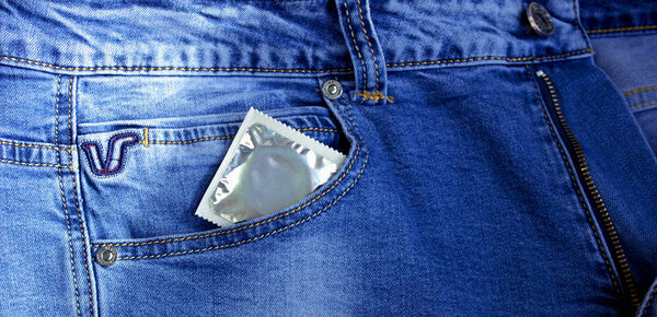 Condom in blue jeans