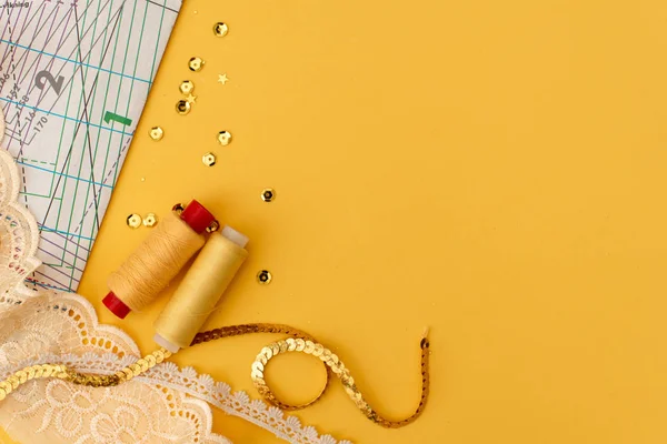 Set of tailoring accessories on grey background, top view